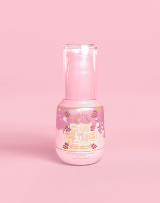 Pink bottle of P. Louise Erase The Trace Dark Spot Correcting Serum on a pink background