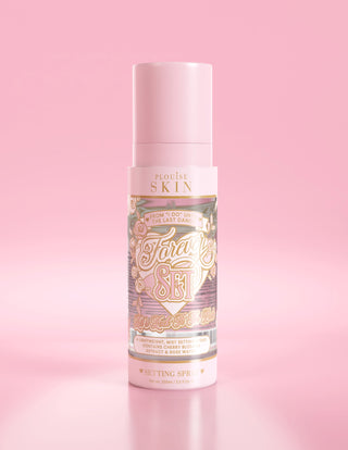 A pink bottle of P. Louise Forever Set Bridal Setting Spray against a light pink background