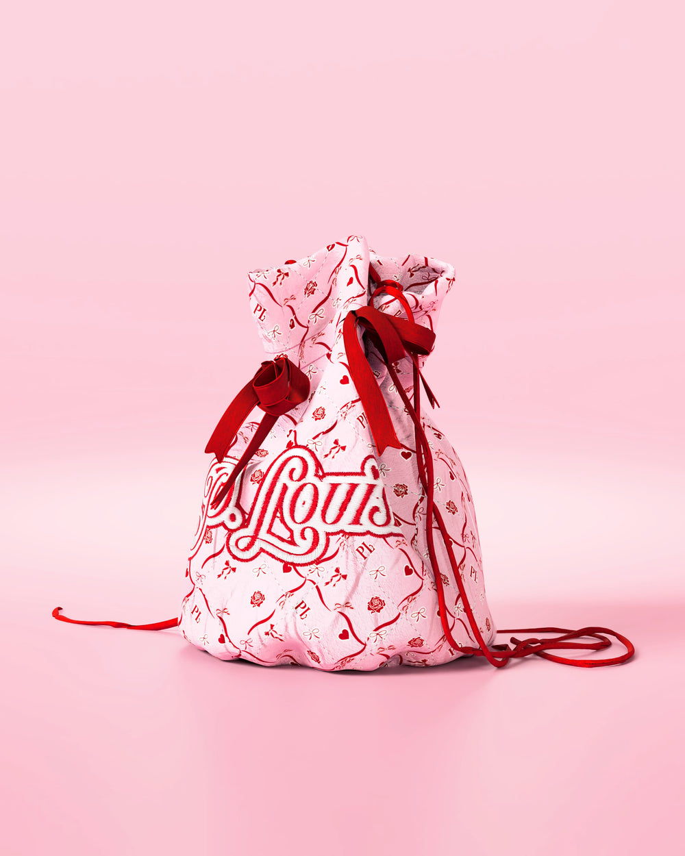 Pink drawstring bag with red bows and a festive design with 'P.Louis' branding on a pink background